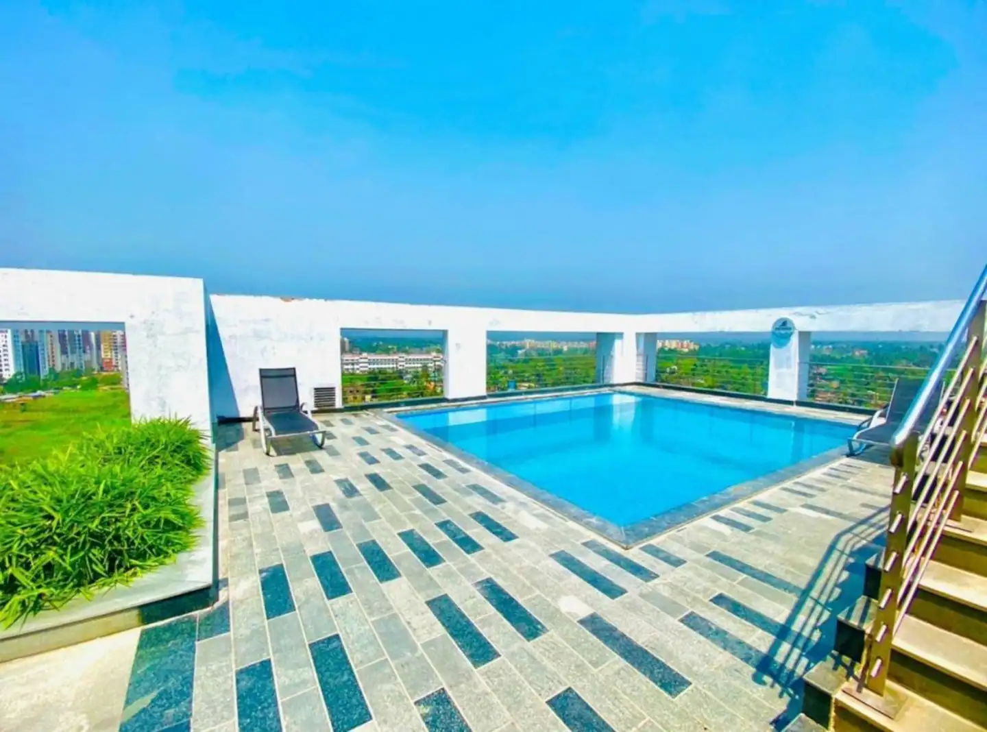 Rooftop swimming pool at Siddha Sky apartments near CC2 Mall Kolkata - Premium amenities at Xanadu Stays