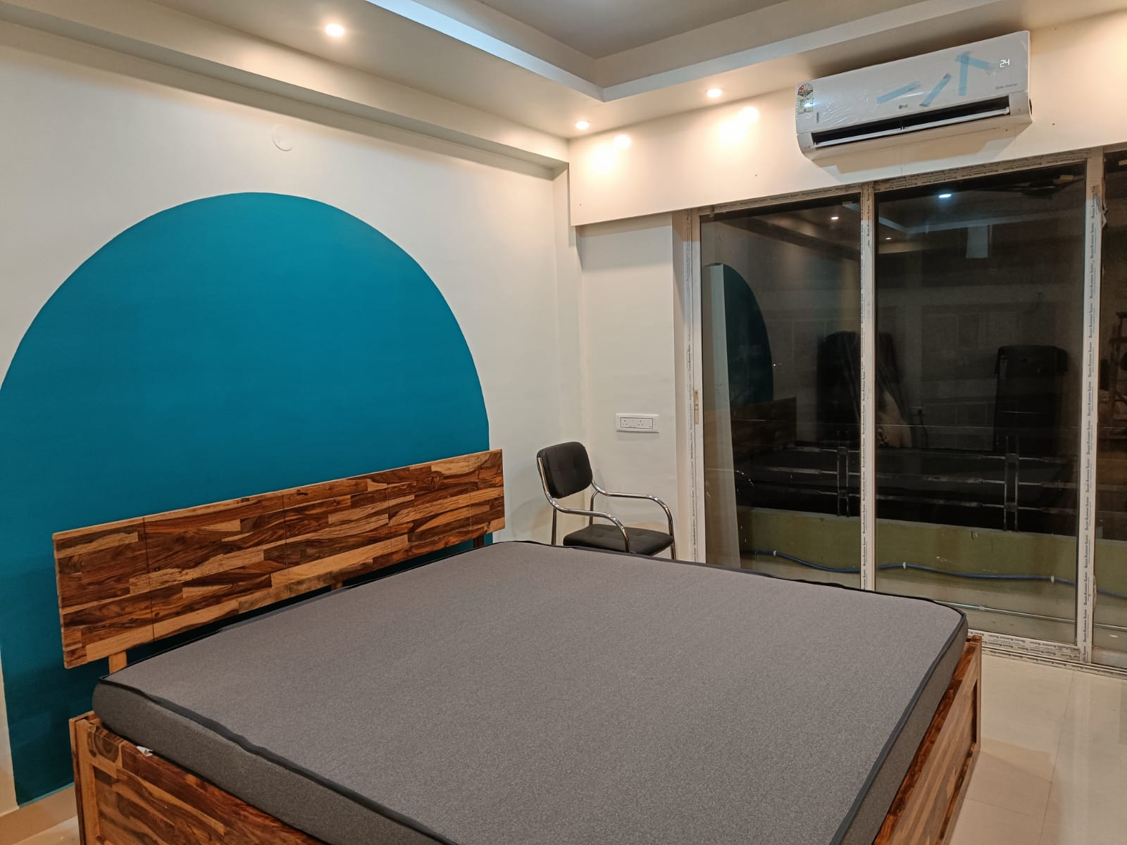 Furnished studio apartment living room near Kolkata Airport with modern decor and city views - Xanadu Stays